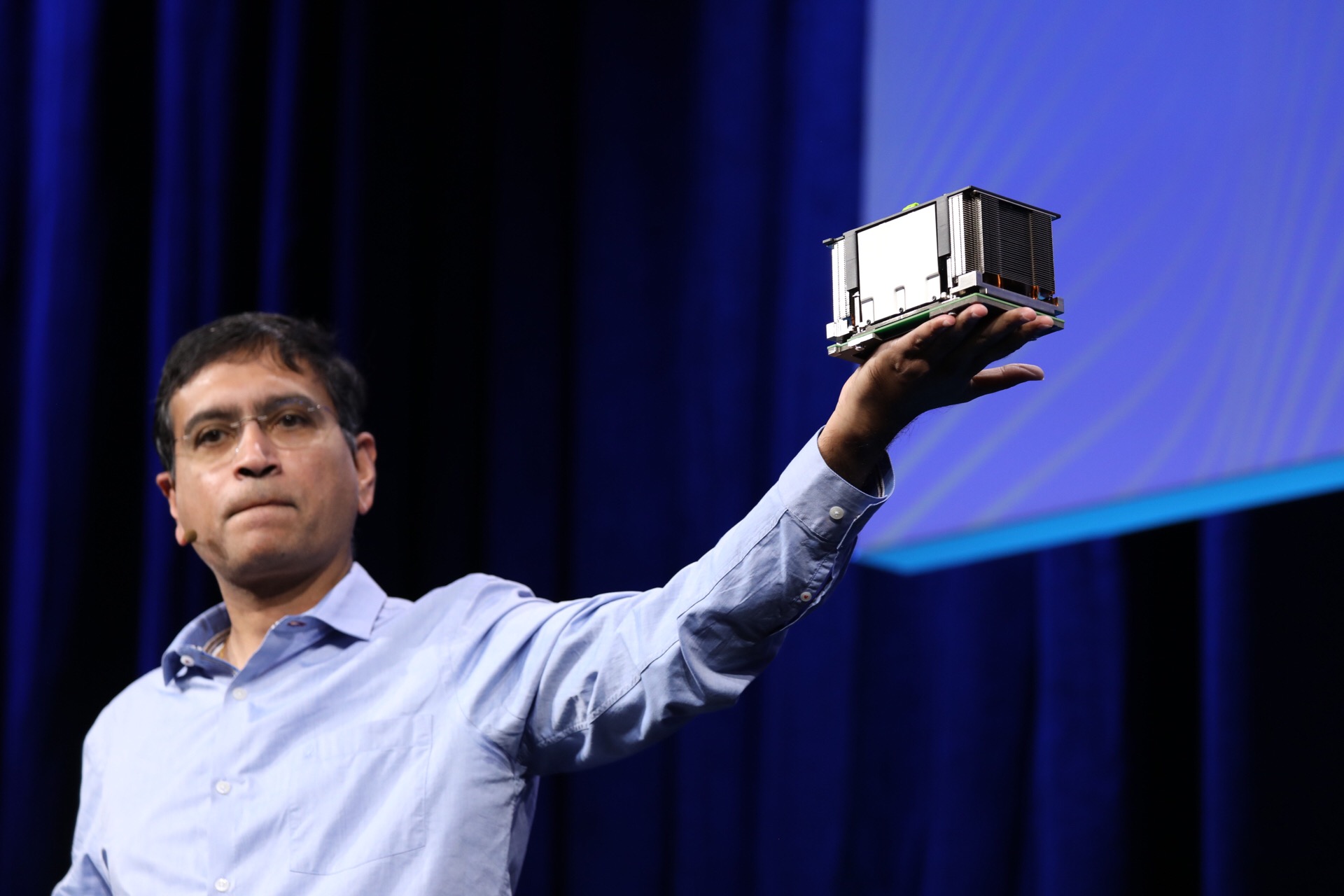 Vijay Rao, Facebook director of technology and strategy, holding up an OCP accelerator module during a keynote at the 2019 OCP Summit