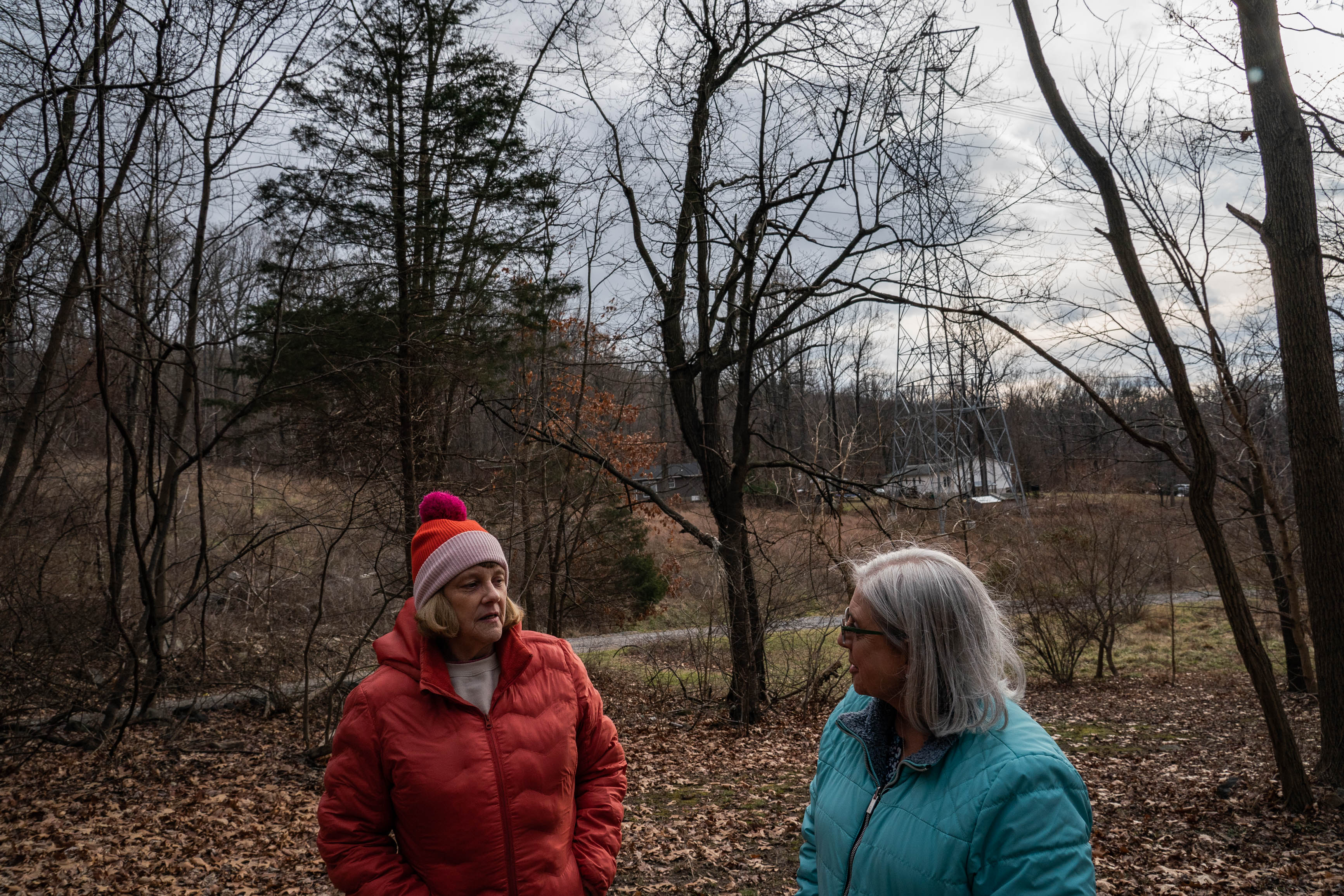 Pam Gearhart, left, speaks with activist Keryn Newman as she explains how close the transmission lines are to her Harpers Ferry property.