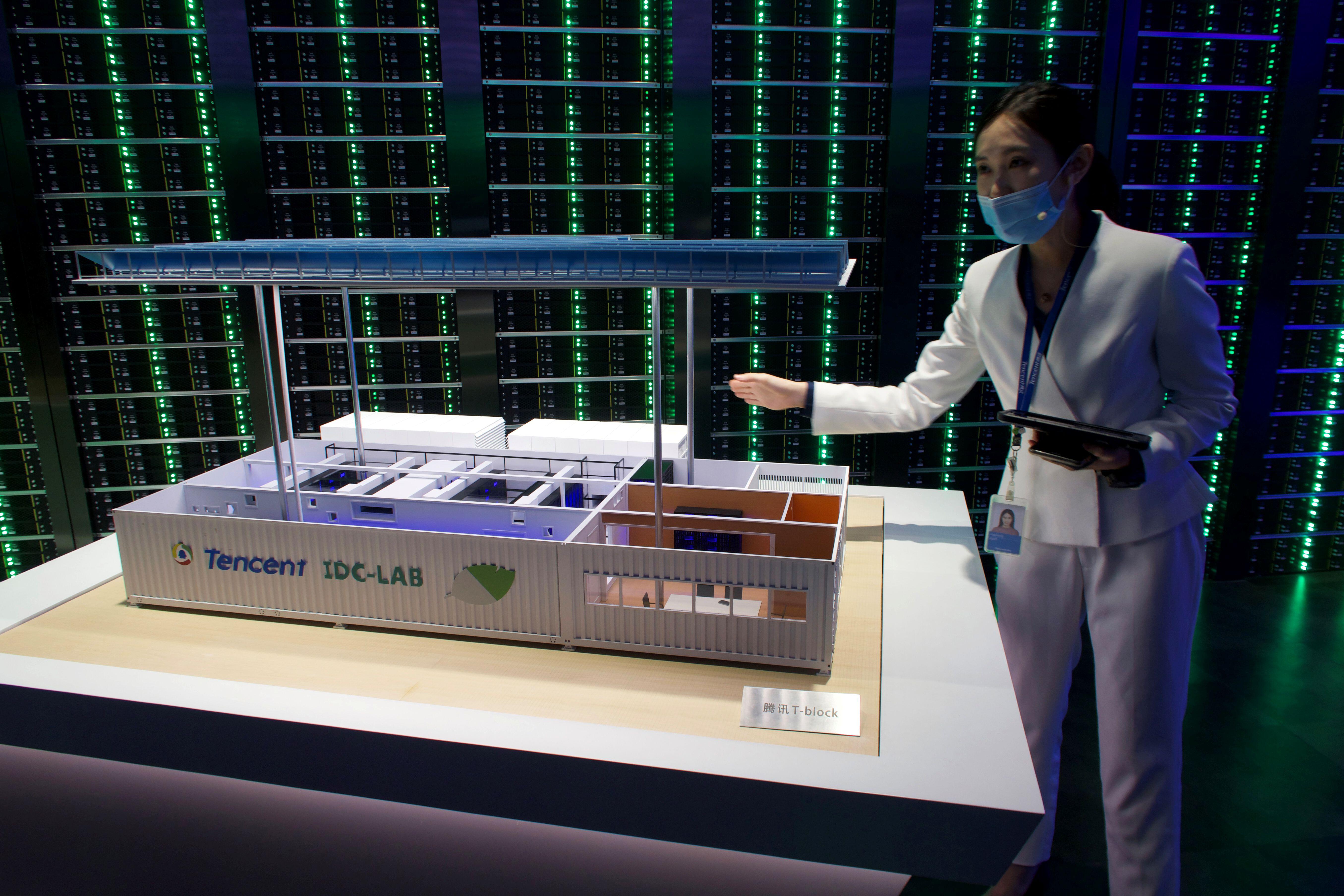 A staff member introduces Tencent's Internet Data Center (IDC) cloud computing service during a government-organized media tour to Tencent headquarters in Shenzhen, Guangdong province China September 27, 2020.
