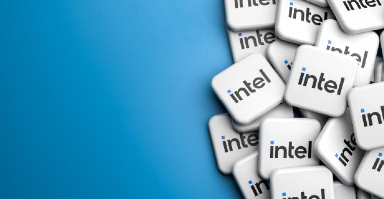 Logos of the tech company Intel on a heap on a table. Copy space. Web banner format.