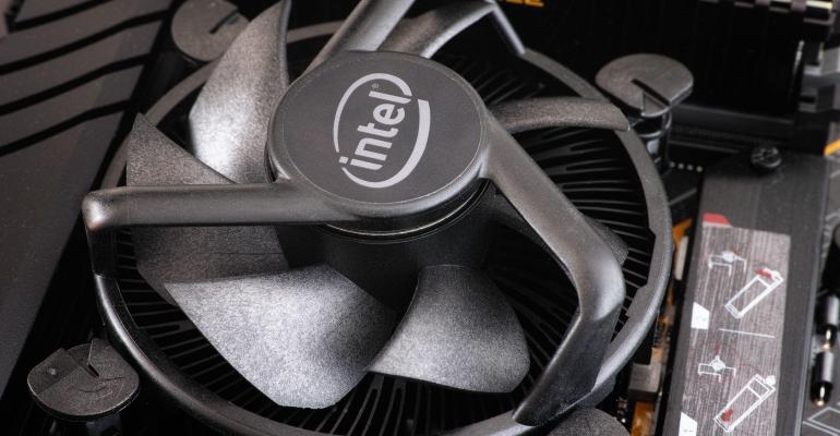 An Intel CPU fan installed onto an Intel i5 CPU. Close up.