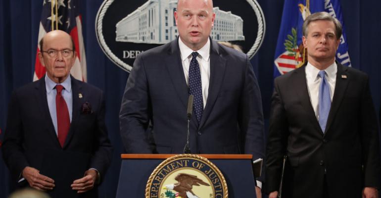 Acting U.S. Attorney General Matthew Whitaker (C) announces new criminal charges against Chinese telecommunications giant Huawei with Federal Bureau of Investigation Director Christopher Wray (R) and Commerce Secretary Wilbur Ross at the Department of Justice January 28, 2019 in Washington, DC.