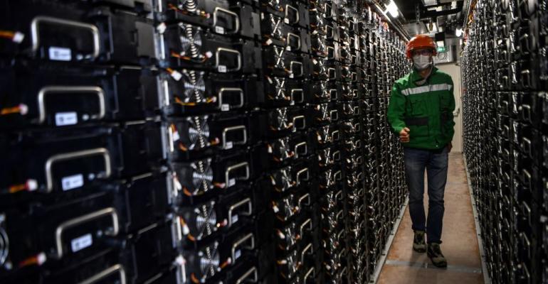 A worker controls batteries in an electricity storage container near Dijon, France, part of "Ringo," an energy storage project. (September 2020)