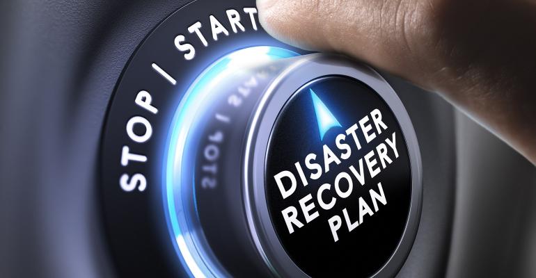 hand turning a dial to start disaster recovery plan