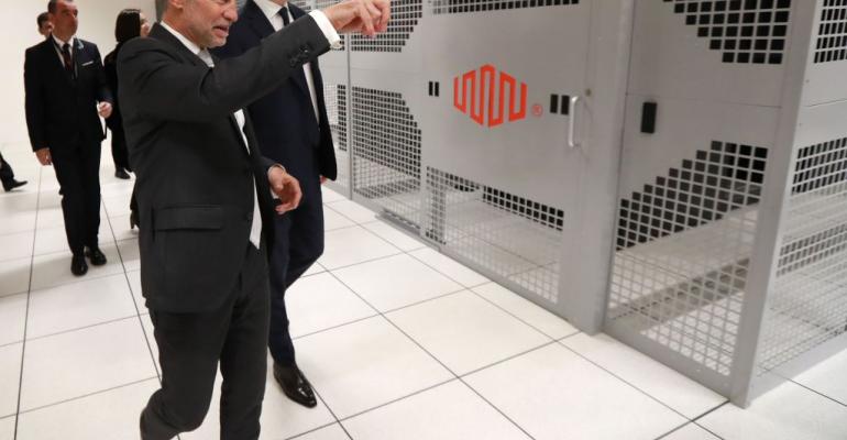 French Economy Minister Bruno Le Maire (R) listens to Regis Castagne (L), managing director of Southern European Equinix Data Center, during the inauguration of the Equinix data center in a suburb of Paris called PA8.