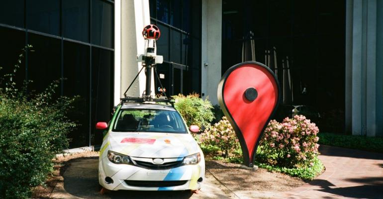 A Google Streetview car and an oversized Google Maps pin parked in front of the Google Maps building at the Googleplex in Mountain View (2018)