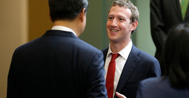 Chinese President Xi Jinping, left, talks with Facebook CEO Mark Zuckerberg, right, during a gathering of CEOs and other executives at Microsoft's main campus September 23, 2015 in Redmond, Washington.
