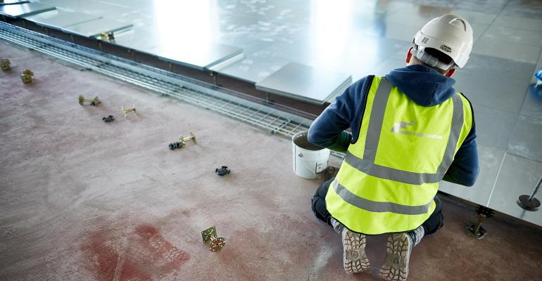 worker installing a raised floor