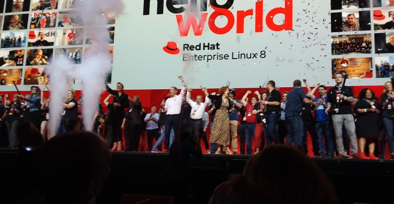 Stage full of people celebrating launch of RHEL 8 at Red Hat Summit 2019