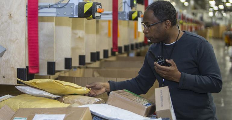 Postal Service employees perform spot checks to ensure packages are properly handled and sorted.