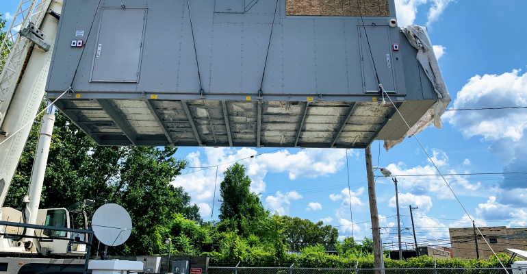 A self-contained Vapor Edge Module (VEM) being craned onto a concrete pad in Pittsburgh