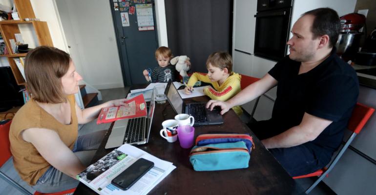 Two parents telework from home with their two boys aged two and seven years, due to schools closing because of the Coronavirus outbreak on March 19, 2020 in 15th district of Paris.