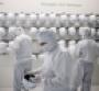 Employees prepare to enter a clean room inside the Infineon Technologies AG semiconductor factory in Villach, Austria.
