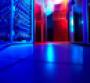 Interior photo of a modern data center with blue lights.