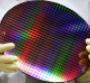 An assistant presents a dummy of a 300 millimeter wafer at AMD Advanced Micro Device on October 14, 2005 in Dresden, Germany