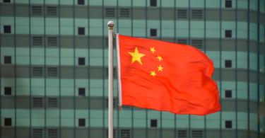 Chinese flag in front of building