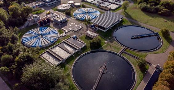 Water treatment facility in The Netherlands seen from above with various water tanks and adjacent buildings.