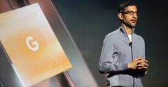 Image of Google CEO Sundar Pichai speaking on stage at an event.