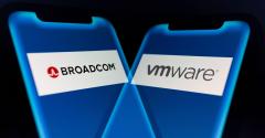 Illustration: In-camera multiple exposure image shows logos of Broadcom (NASDAQ: AVGO), a global technology company, and VMware, a provider of multi-cloud services, on smartphone.