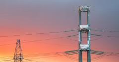 High voltage power transmission line on sunset background 
