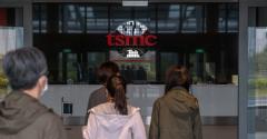 People entering a TSMC office building.