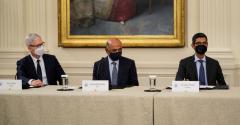Apple CEO Tim Cook, IBM CEO Arvind Krishna and Google CEO Sundar Pichai listen as U.S. President Joe Biden speaks during a meeting about cybersecurity in the East Room of the White House.