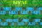 New York Stock Exchange stock trading board listings moving across US dollar bills. 