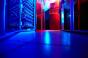 Data center server room with blue and red lighting.