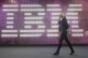 A young woman walks past the IBM logo at the 2009 CeBIT technology trade fair in Hanover, Germany.