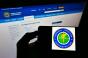Person holding smartphone with seal of US agency Federal Aviation Administration (FAA) on screen in front of website.