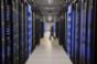 An employee walks past servers in the Facebook data center in Forest City, North Carolina.