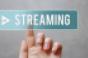 finger pushing live streaming button