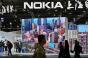 People walk past the Nokia booth during the Mobile World Congress in Shanghai on February 23, 2021.