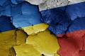ukraine and russia flags on broken cement