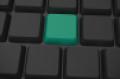 black keyboard with green key