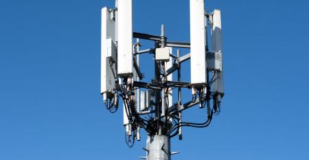 A close-up of a mobile phone mast against a clear sky