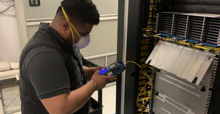 A CoreSite engineer testing a cross-connect for acceptable light loss at the company’s data center in Chicago.