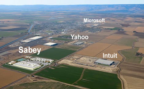 An aerial view of Quincy, Washington showing the cluster of major data centers, including a visualization of a planned site for Sabey Corp. and existing sites for Microsoft, Yahoo and Intuit.  A coalition of data center companies is seeking to reinstate tax breaks in Washington state that helped develop the Quincy cluster. (Image: Sabey Corp.).