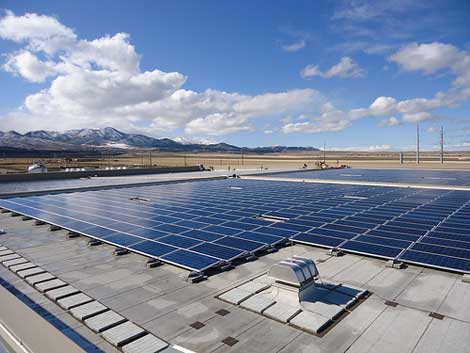 Sun and clouds reflect the large surface of the solar array atop eBay's Topaz Data Center in South Jordan, Utah.