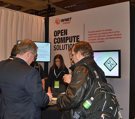 Attendees to the Open Compute Summit IV converse at the Avnet booth. (Photo by Colleen Miller.)