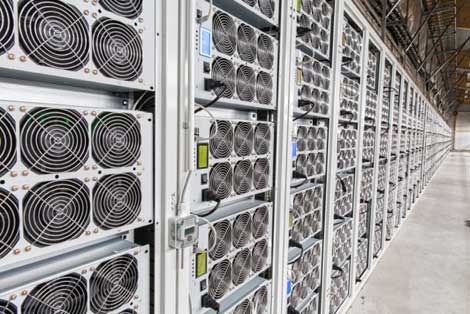These racks of high-density Bitcoin mining rigs stretch the length of the building in the BitFury hashing center in  the Republic of Georgia. (Photo: BitFury)