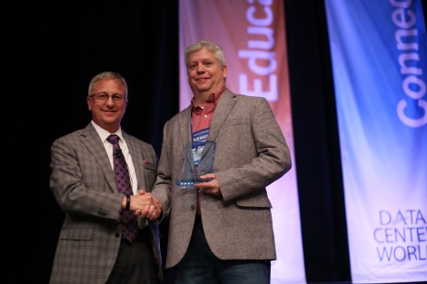 AFCOM President Tom Roberts presents an award to Brian Smith, director of critical facilities at Cerner Corp. Smith was one of the three finalists in this year’s Data Center Manager of the Year awards.